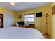 Comfortable bedroom with bright walls, tiled floors, and a wardrobe at 403 Gulf Way # 504, St Pete Beach, FL 33706