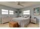 Comfortable bedroom with tile floors, two windows with views, and soft, neutral tones for a relaxing atmosphere at 403 Gulf Way # 504, St Pete Beach, FL 33706