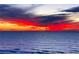 Beautiful ocean view featuring a vibrant sunset with orange and red hues over the calm sea at 403 Gulf Way # 504, St Pete Beach, FL 33706