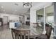 Charming dining area with round table and four chairs, near kitchen and sliding doors to patio at 12821 Bergstrom Bay Dr, Riverview, FL 33579