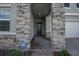 Front entry with stone pillars and a dark-colored front door at 12821 Bergstrom Bay Dr, Riverview, FL 33579
