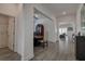 Bright hallway with wood-look tile flooring, leading to dining area and other rooms at 12821 Bergstrom Bay Dr, Riverview, FL 33579