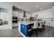 Modern kitchen boasts white cabinets, a large island with blue base, and stainless steel appliances at 12821 Bergstrom Bay Dr, Riverview, FL 33579