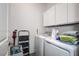 Laundry room with washer, dryer, and overhead cabinets at 12821 Bergstrom Bay Dr, Riverview, FL 33579