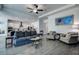 Open living space with hardwood floors, a comfortable sofa and armchairs, and views of the kitchen at 12821 Bergstrom Bay Dr, Riverview, FL 33579