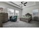 Main bedroom with tray ceiling, large windows and a relaxing armchair at 12821 Bergstrom Bay Dr, Riverview, FL 33579