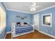 Bedroom with daybed, light blue walls, and wood floors at 20204 Gulf Blvd # 9, Indian Shores, FL 33785