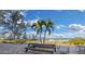 Beachfront patio with picnic table and lounge chairs at 20204 Gulf Blvd # 9, Indian Shores, FL 33785