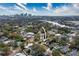 Aerial view of a city skyline and a waterfront residential area, surrounded by green spaces and trees at 1002 W Charter St, Tampa, FL 33602
