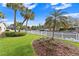 Landscaped backyard with a white picket fence and palm trees at 5269 Dover Ne St, St Petersburg, FL 33703