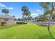 Green grassy backyard, partially bordered by a white picket fence at 5269 Dover Ne St, St Petersburg, FL 33703