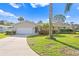 Tan house with a curved driveway and palm trees at 5269 Dover Ne St, St Petersburg, FL 33703