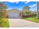 Tan house with landscaping and a long driveway at 5269 Dover Ne St, St Petersburg, FL 33703