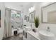 Modern bathroom with double vanity, marble tile, and soaking tub at 5334 37Th N St, St Petersburg, FL 33714