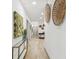 Long hallway with light wood floors and wall art at 5334 37Th N St, St Petersburg, FL 33714