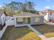 Single story home with green door and landscaped yard at 5334 37Th N St, St Petersburg, FL 33714