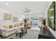 Cozy living room with a white sofa, arm chair, and sliding glass doors to patio at 5334 37Th N St, St Petersburg, FL 33714