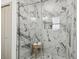 Large walk-in shower with marble tile and glass enclosure at 5334 37Th N St, St Petersburg, FL 33714