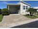 Single-wide manufactured home with carport and landscaped yard at 13225 101St St # 482, Largo, FL 33773