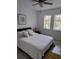 Bedroom with queen-size bed, ceiling fan, and two windows at 2101 Sunset Point Rd # 1302, Clearwater, FL 33765