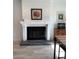 Modern fireplace with a dark glass screen and gray tile hearth at 2101 Sunset Point Rd # 1302, Clearwater, FL 33765