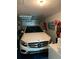 Garage with car, shelving, and beach items at 2101 Sunset Point Rd # 1302, Clearwater, FL 33765