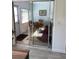 Sunroom with glass sliding doors and wicker furniture at 2101 Sunset Point Rd # 1302, Clearwater, FL 33765