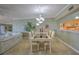 Bright dining area with chandelier and view into living room at 18400 E Gulf Blvd # Ph-11, Indian Shores, FL 33785