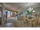 Bright dining room with table and chairs, looking toward living room and balcony at 18400 E Gulf Blvd # Ph-11, Indian Shores, FL 33785