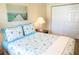 Bedroom with a queen bed and beach themed bedding at 357 S Mcmullen Booth Rd # 120, Clearwater, FL 33759