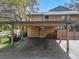 Carport with golf cart and bicycle at 103 Cypress Pond Rd # 103, Palm Harbor, FL 34683