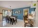 Charming dining room with a blue accent wall and seating for six at 103 Cypress Pond Rd # 103, Palm Harbor, FL 34683