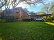 Exterior of condo showing carport and well-manicured lawn at 103 Cypress Pond Rd # 103, Palm Harbor, FL 34683