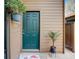 Condo front door with welcome mat and potted plant at 103 Cypress Pond Rd # 103, Palm Harbor, FL 34683