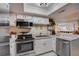 Modern kitchen with stainless steel appliances and white cabinets at 103 Cypress Pond Rd # 103, Palm Harbor, FL 34683