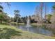 Serene pond with a fountain, enhancing the community's natural beauty at 103 Cypress Pond Rd # 103, Palm Harbor, FL 34683