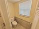 Small bathroom with toilet and window for natural light at 8304 Bardmoor Blvd # 104, Seminole, FL 33777