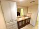 Double vanity bathroom with granite countertop and linen cabinet at 8304 Bardmoor Blvd # 104, Seminole, FL 33777