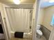 Bathroom with shower/tub combo, toilet, and updated tile flooring at 8304 Bardmoor Blvd # 104, Seminole, FL 33777