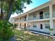 Light beige condo building with balconies and green space at 8304 Bardmoor Blvd # 104, Seminole, FL 33777