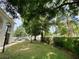 Condo building with a tree-lined pathway and parking at 8304 Bardmoor Blvd # 104, Seminole, FL 33777