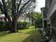 Condo building with a large tree and landscaping at 8304 Bardmoor Blvd # 17 104, Seminole, FL 33777