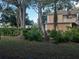 Two story building with lush landscaping and tree coverage at 8304 Bardmoor Blvd # 17 104, Seminole, FL 33777