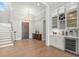 Bright entryway with hardwood floors and wine bar at 266 8Th N Ave, Tierra Verde, FL 33715