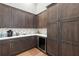 Butler's pantry with dark wood cabinets, quartz countertops and wine cooler at 266 8Th N Ave, Tierra Verde, FL 33715