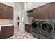 Laundry room with modern appliances and stylish hexagon tile floor at 266 8Th N Ave, Tierra Verde, FL 33715