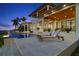 Luxury pool and patio area with lounge chairs at dusk at 266 8Th N Ave, Tierra Verde, FL 33715