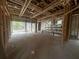 Interior under construction featuring an open concept living space with exposed framing and plumbing at 8418 Fussell Dr, Wesley Chapel, FL 33545