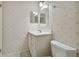 Clean bathroom with vanity, toilet and shower at 6302 Pelican Creek Xing # A, St Petersburg, FL 33707