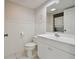 Bathroom with vanity, toilet and stacked washer/dryer at 6302 Pelican Creek Xing # A, St Petersburg, FL 33707